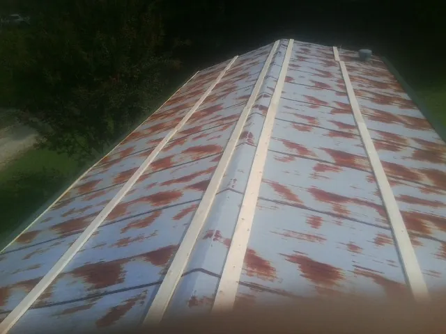 Rusted metal roof panels with new wood purlins before replacement — Storm Damage Roof Repair in Hockley by Roofing Brothers