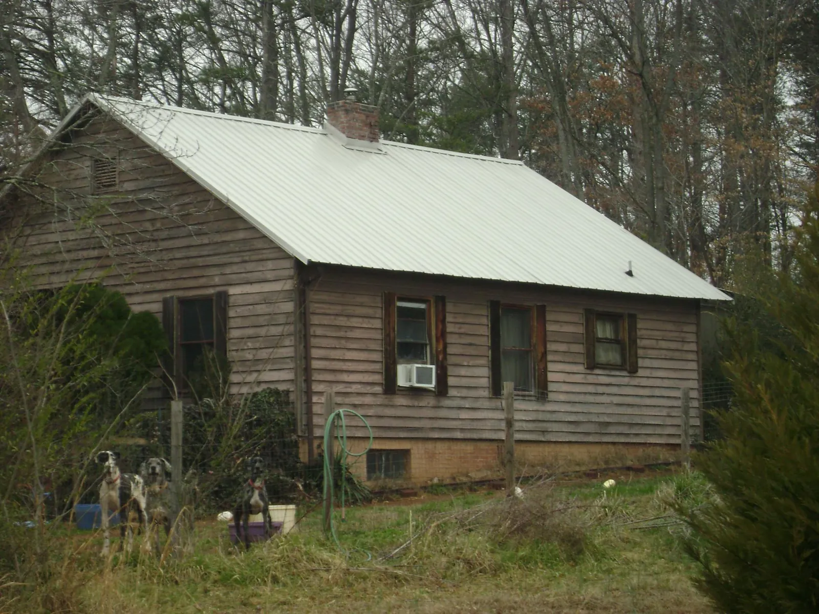 White metal roof on an old wood sided farmhouse, from a Metal Roof Installation job in Hockley
